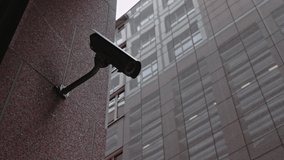 Security camera moving panning and tilting recording what's happening outside a building. Motorized CCTV surveillance concept - Powered by Shutterstock - Get 15% off with code: PIKWIZARD15