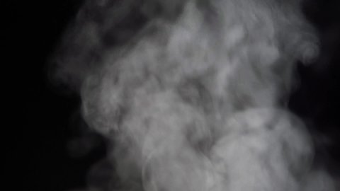 steam on a black background. white smoke or steam rises. cloud of thick smoke. abstract background footage. thick steam from a frying pan or pot on the stove. water vapour
