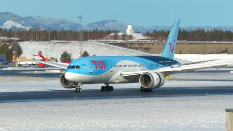 Oslo Airport Norway - February 6 2022: tui airways airplane boeing 787 landing in distance oslo airport norway