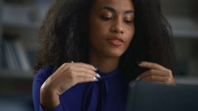 Beautiful african american ceo woman calling video using laptop discuss project online in cafe. Portrait of focused businesswoman talking negotiating deal in office close up. Remote work concept.