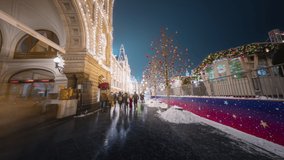 Beautiful walk along the decorated streets in the center of Moscow on New Year holidays. Crowds of people moving in front of illuminated GUM facade and Christmas fair in motion timelapse.