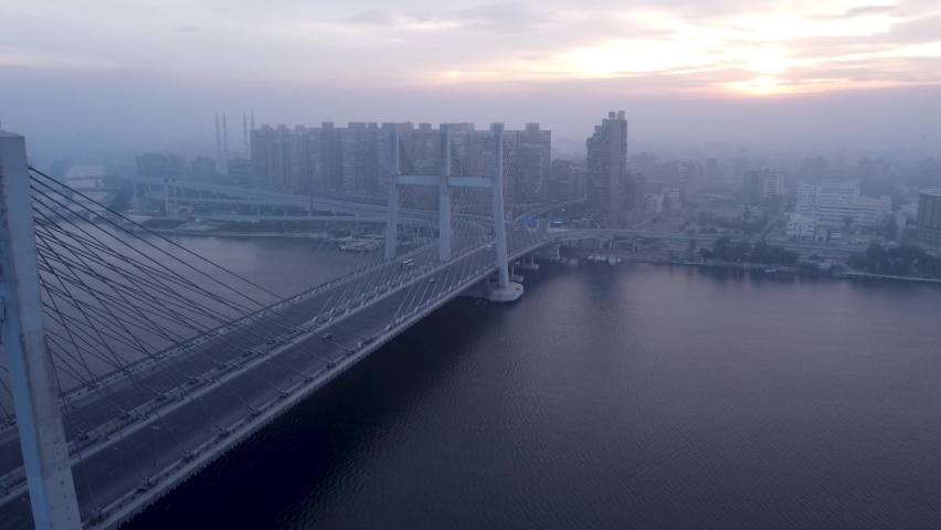 Drone video of the Tahya Misr bridge above the Nile and the Rod al-Farag axis at sunrise Royalty-Free Stock Footage #1086795746