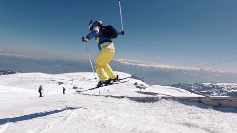 Slow motion of a skier doing incredible ski jumping of a slope