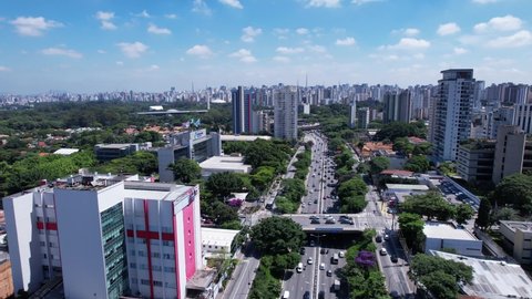 Aerial view of Sao Paulo city, in 23 de Maio avenue, north-south corridor. Prevervetion area with trees and green area of Ibirapuera park in Sao Paulo city, Brazil.