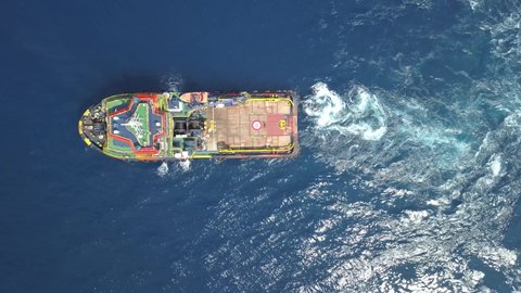 Aerial view from a drone of an offshore Supply Vessel For Oil Drilling Rig in The Middle of Ocean
