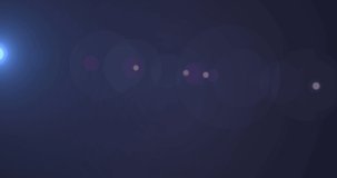 Animation of glowing blue light over spots of light on purple background. light and movement concept digitally generated video.