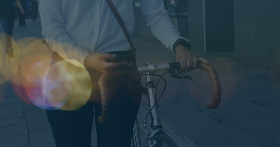Animation of shapes moving over biracial woman using smartphone and walking with bicycle. pedal day and celebration concept digitally generated video.