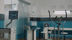 Empty rehabilitation cabinet to help with physiotherapy, using stationary bicycle to increase mobility and heart rate monitor to measure pulse. Alternative medicine to cure mechanical disorders. - Powered by Shutterstock - Get 15% off with code: PIKWIZARD15