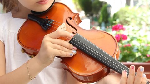 Girl playing violin with fingers