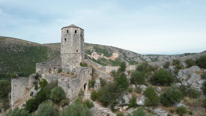 Drone view of the stone-built watch and defense fort overlooking the Neretva river, drone view of the historic fort in Pocitelj Bosnia