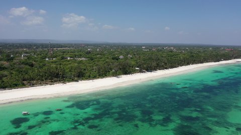 Drone Coastline Diani beach landscape Kenyan African Sea  aerial 4k waves blue indan ocean tropical mombasa turquoise white sand East Africa palms paradise view Wood boats on water
