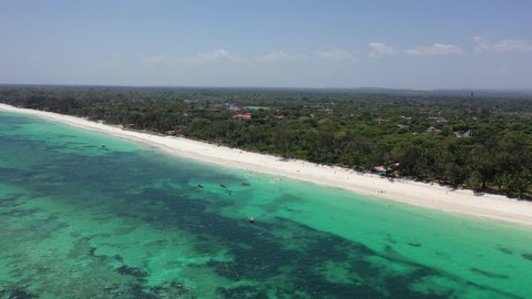 Drone Coastline Diani beach landscape Kenyan African Sea  aerial 4k waves blue indan ocean tropical mombasa turquoise white sand East Africa palms paradise view Wood boats on water