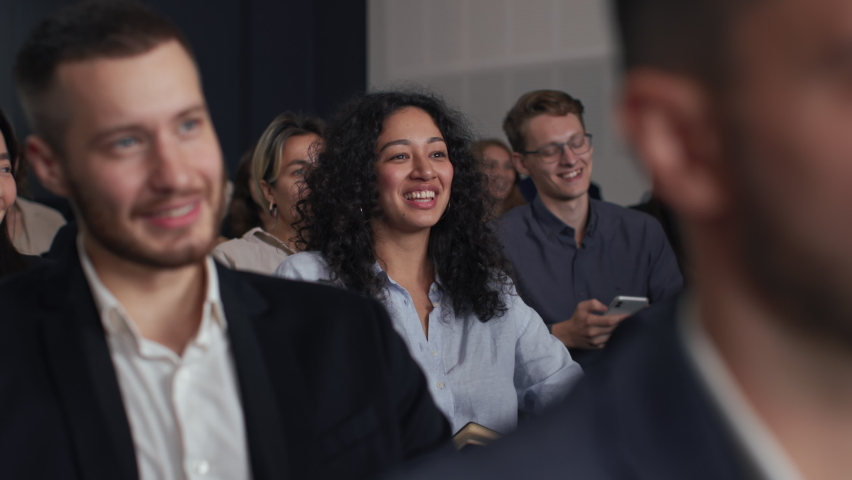 Group of people listens speech at business conference. Stage talk at summit meeting in crowded modern hall. Mixed race woman training at economic forum. Business work of sitting female person indoors | Shutterstock HD Video #1086821444