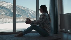 GO Everywhere.A woman sits near the window and drinks tea from a mug. - Powered by Shutterstock - Get 15% off with code: PIKWIZARD15