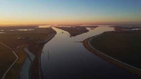Aerial view over the IJsseldelta and the river IJssel during sunrset during a cold winter afternoon in Overijssel, Netherlands.
