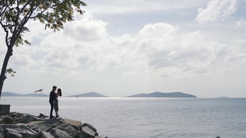 couple hugging on a cliff