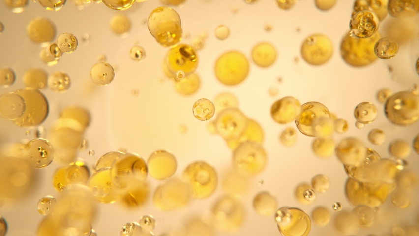 Super Slow Motion Shot of Oil Bubbles on Golden Background at 1000fps. Shoot on high speed cinema camera. Royalty-Free Stock Footage #1086829472
