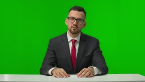 Male newsanchor informing about current news. Professional television live reporter talking about recent global events in business and politics. Chroma key green background