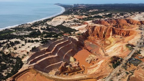 Aerial view of sand mining extraction shaping the rock coastline of Vietnam. Aerial view of construction site for big infrastructure highway