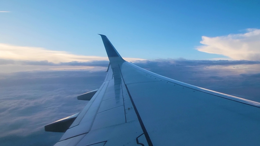 Close Up View Of Aircraft Wing In Flight At Sunrise Surrounded By Clouds. POV Royalty-Free Stock Footage #1086835406
