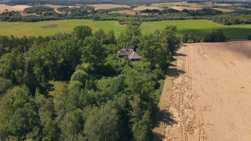 Mysterious old house in the middle of the field forest. Drone aerial footage
