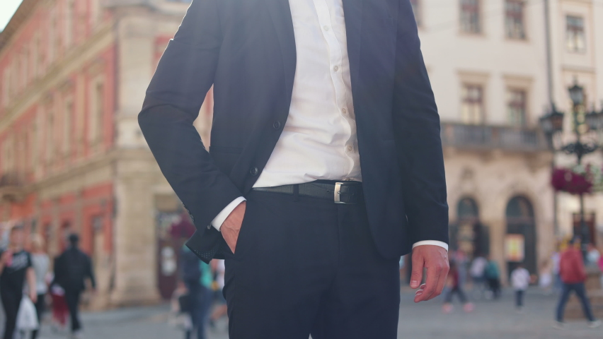 Bad news, Disappointed man in formal suit answering call and looking upset. Ofice worker taking smartphone out of pocket. Caucasian male entrepreneur talking on mobile phone while going to work.