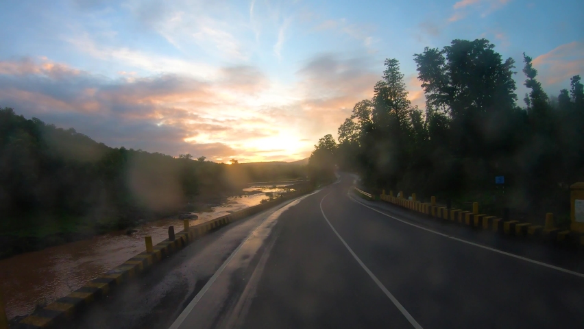 4K POV Hyper lapse of the dashcam of vehicle with dirty windshield moving through the green forests and besides river during morning at Dang district on the way to Saputara in Gujarat, India. | Shutterstock HD Video #1086839177