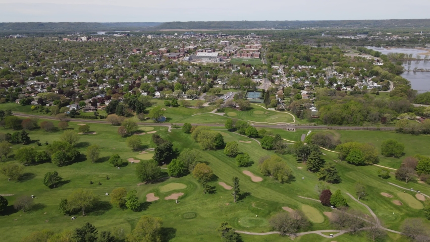 View from mountain in Wisconsin. Golf course at the base of the mountain with railroad tracks, highways, wetlands, homes, and mountains along the Mississippi River. 