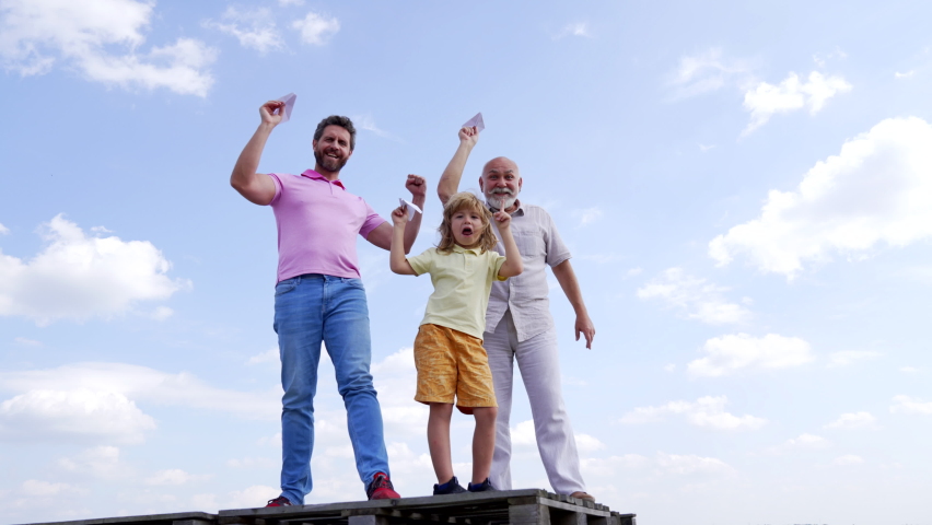 Happy family winners with paper planes enjoy success making winning gesture sky-high, victory