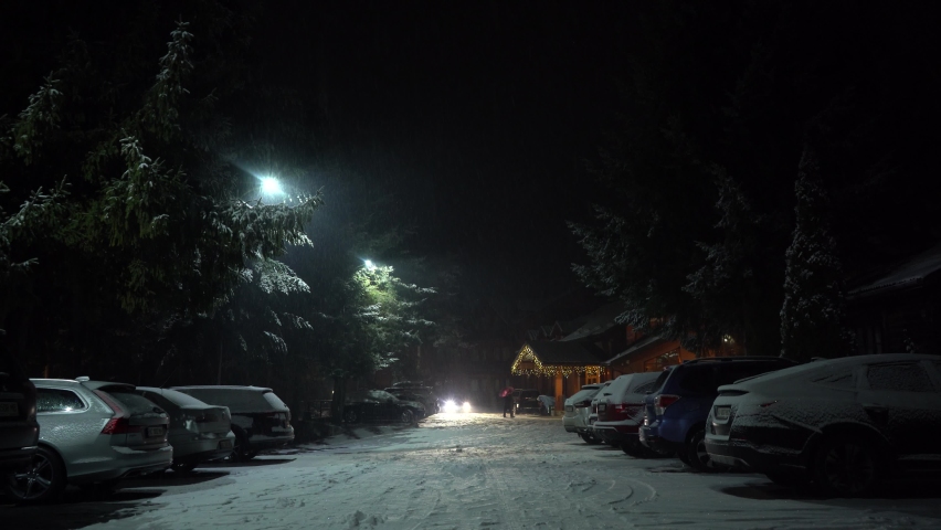 Cars parked near nice cottage in the forest winter tourism christmas time