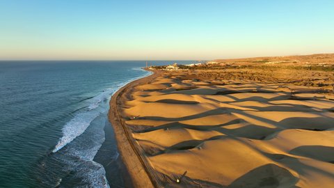 Sand dunes meet the Atlantic Ocean. Top view of Maspalomas sand dunes. Aerial view of Gran Canaria Island.