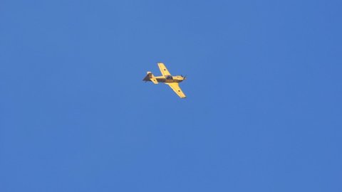Thiene Vicenza Italy OCTOBER, 16, 2021 Stunt airplane performs aerobatics in the clear blue sky. Releasing white smoke. Slow motion footage. Extreme sports. Mudry CAP 231