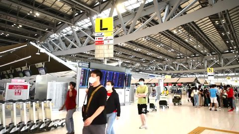 Bangkok, Thailand - Feb 9, 2022 : Traveler walking through departures hall terminal at Suvarnabhumi Airport