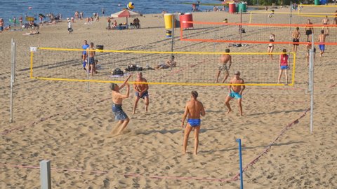 SAMARA, RUSSIA - JUNE 21, 2021: A group of people playing beach volleyball on the sand