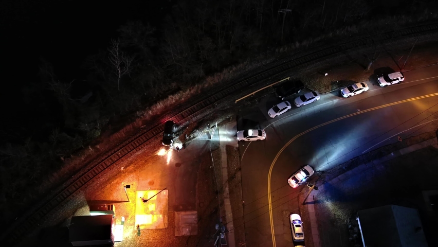 Aerial View of Several Police Cars With a Vehicle on Railroad Tracks