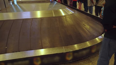 Baggage on the baggage carousel at the airport. Suitcases are spinning on the tape after disembarking from the plane.