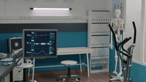 Rehabilitation office with stationary bicycle and heart rate monitor, empty cabinet to treat patients with mechanical disorders. Alternative medicine and physical therapy for osteopathy. - Powered by Shutterstock - Get 15% off with code: PIKWIZARD15