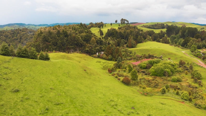 A remote unknown waterfall with colorful valleys and colorful lakes in New Zealand