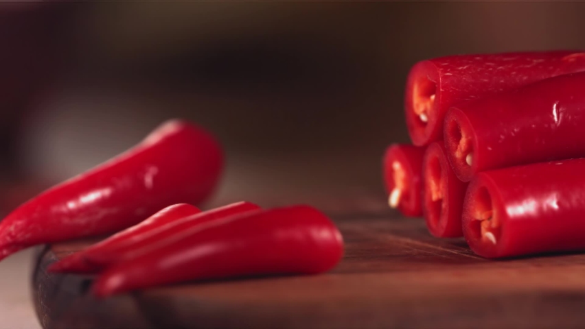 Knife Cutting Red Chilli Pepper on Wood in Slow Motion Royalty-Free Stock Footage #1086871454