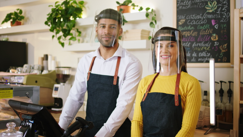 Multiethnic team of barista in the coffee shop charismatic man and woman posing happy with a large smile to the camera Royalty-Free Stock Footage #1086873956