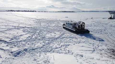 Saratov, Russia - Feb,2022: hovercraft rides on the frozen lake. High quality 4k footage