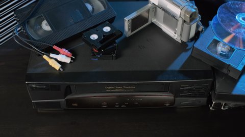 Man Putting Tape into VHS Video Player. Data Archiving, Videotape Cassette Recorder and Old Technology