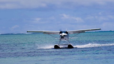 Slow motion view of a float plane landing near Le Morne in Mauritius