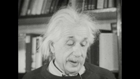 1940s: Hand opens book to reveal portrait of Albert Einstein. Albert Einstein stands near bookshelf and speaks.