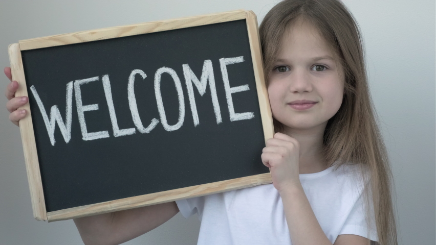 Little girl and Welcome inscription on chalkboard. Education, back to school. Advertising for business
