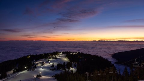 Cinemagraph Loop Animation. Panoramic View of Top of Grouse Mountain Ski Resort with the City in the background. North Vancouver, British Columbia, Canada. Sunset Sky