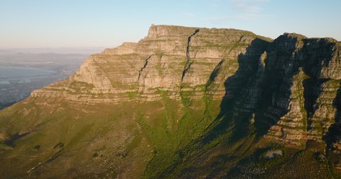 Huge rock wall illuminated by bright sunshine. Forwards fly in Table Mountain National Park. Cape Town, South Africa