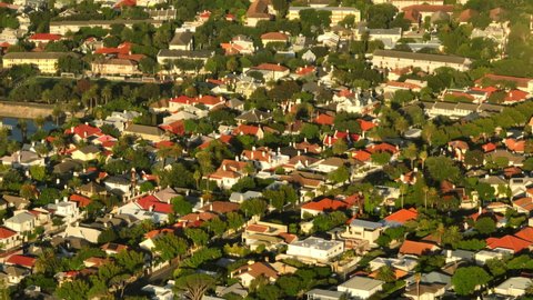 High angle view of houses in residential borough. Fly above buildings in town. Bright sun shining on urban neighbourhood. Cape Town, South Africa