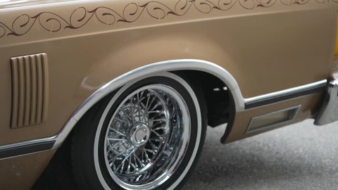 Los Angeles, CA USA - January 20 2022: This panning video shows a close up view of a classic, retro lowrider 1977 - 1978 pinstriped car.