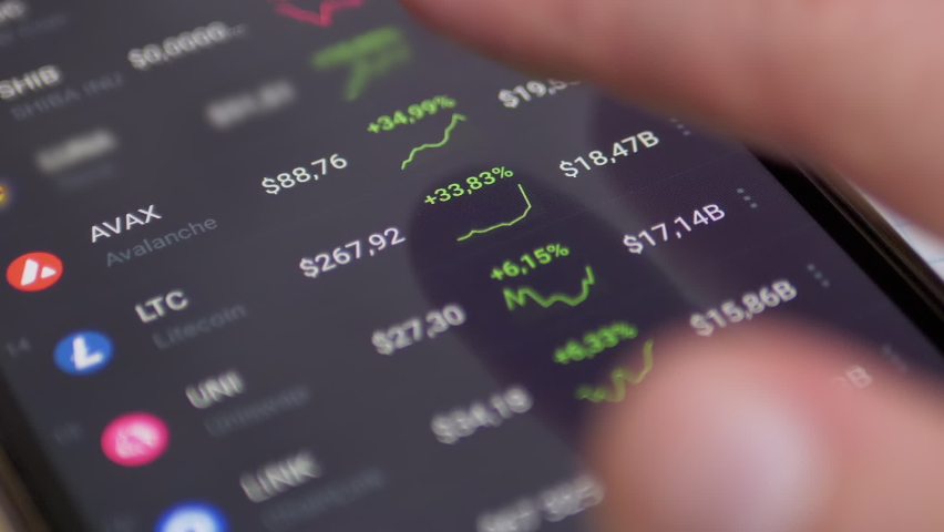Graph Dynamics Price of Cryptocurrencies in App on Screen Smartphone. Businessman touches the screen a finger analyzes financial risks. Trend, index, statistics, data. Online trading. Stock Exchange. | Shutterstock HD Video #1086897146
